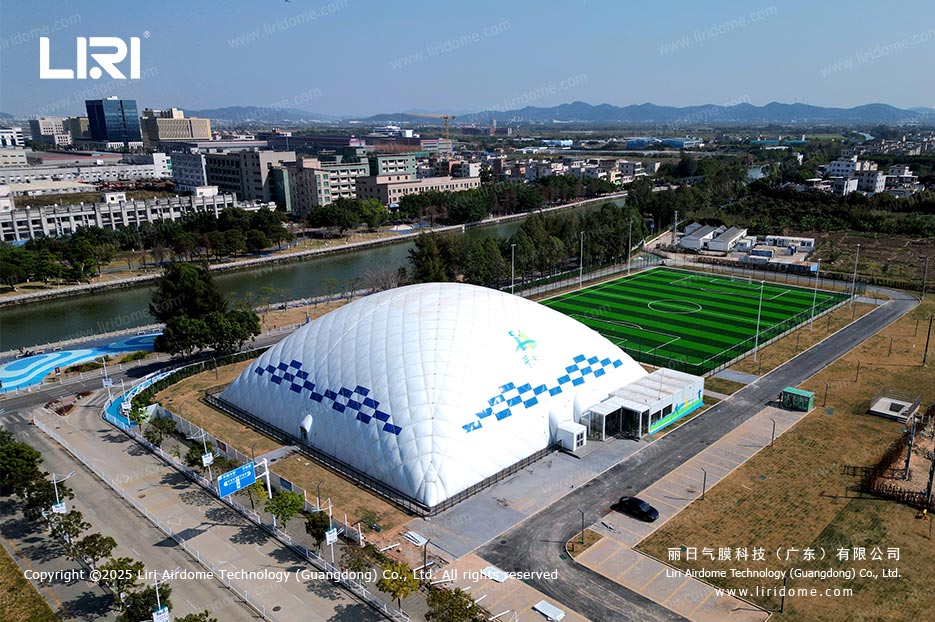 Aerial view of Liri air dome sports venue beside an outdoor soccer field