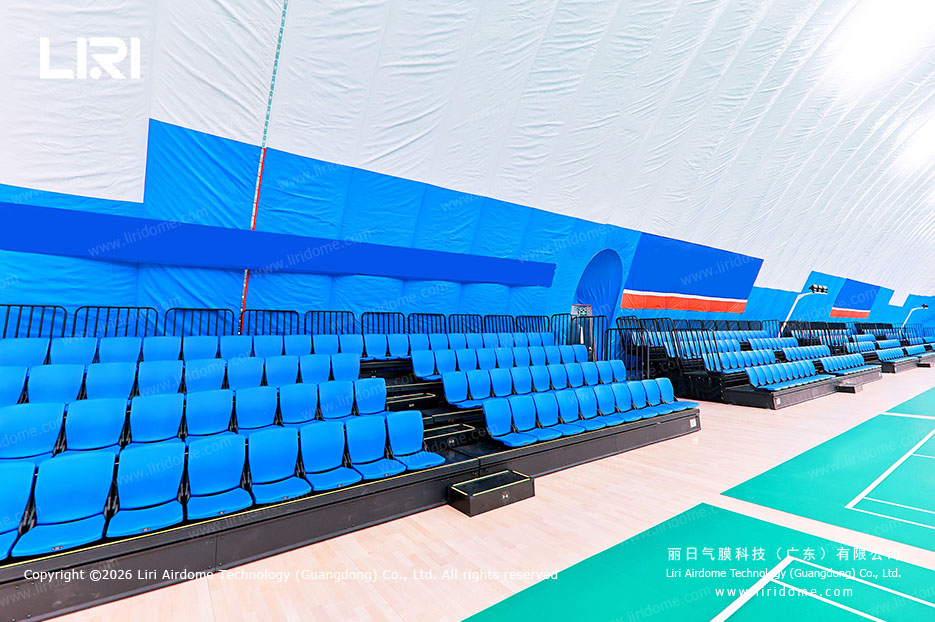 Air dome campus venue with audience seating beside indoor sports courts