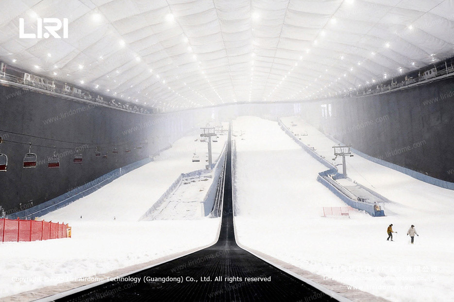 Column-free air dome ski hall interior with lifts and snow runs