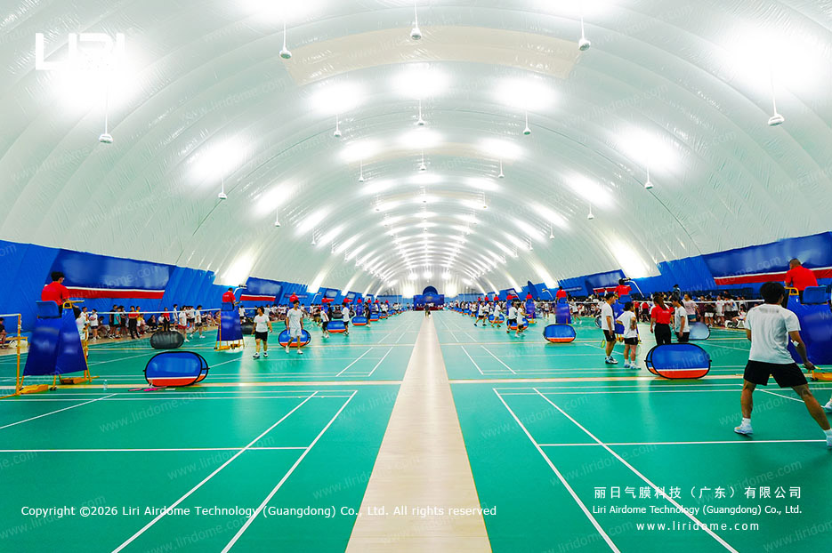 Panoramic interior of badminton courts under a school air dome roof