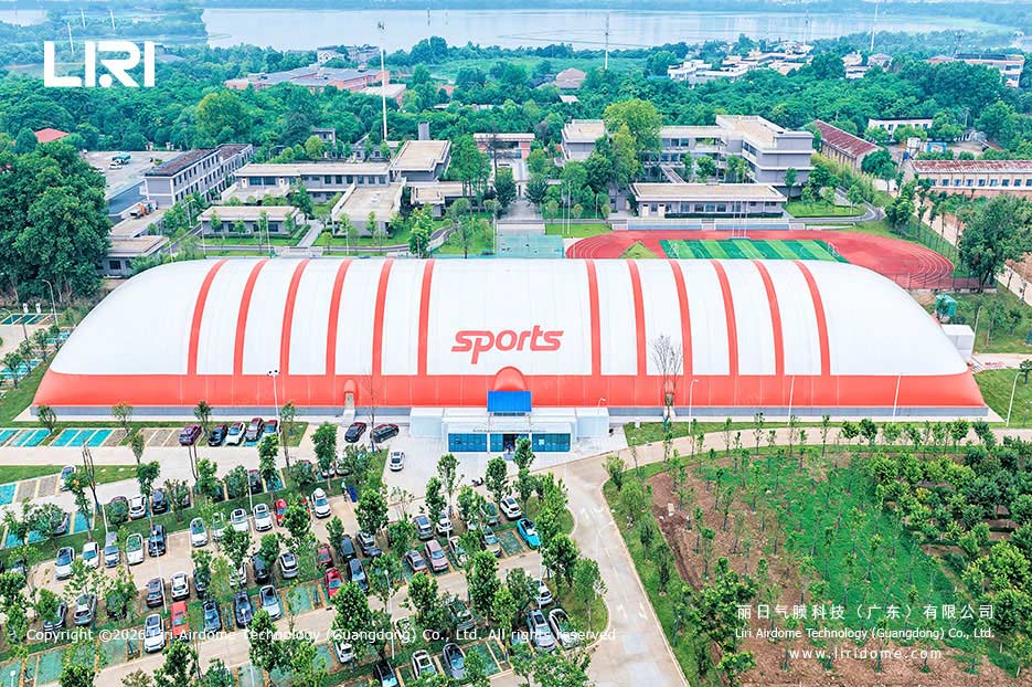 Front entrance aerial view of a school air dome gymnasium on campus