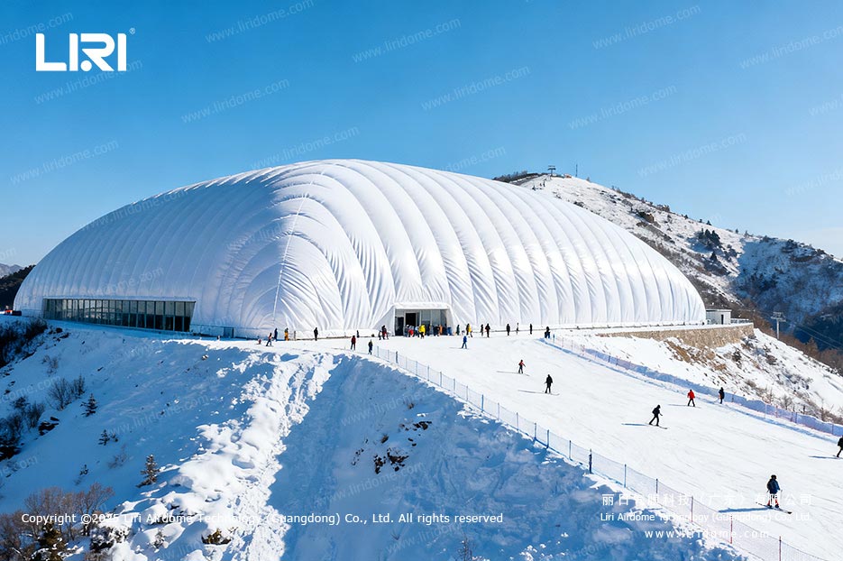 Air dome ski resort beside a snowy mountain slope