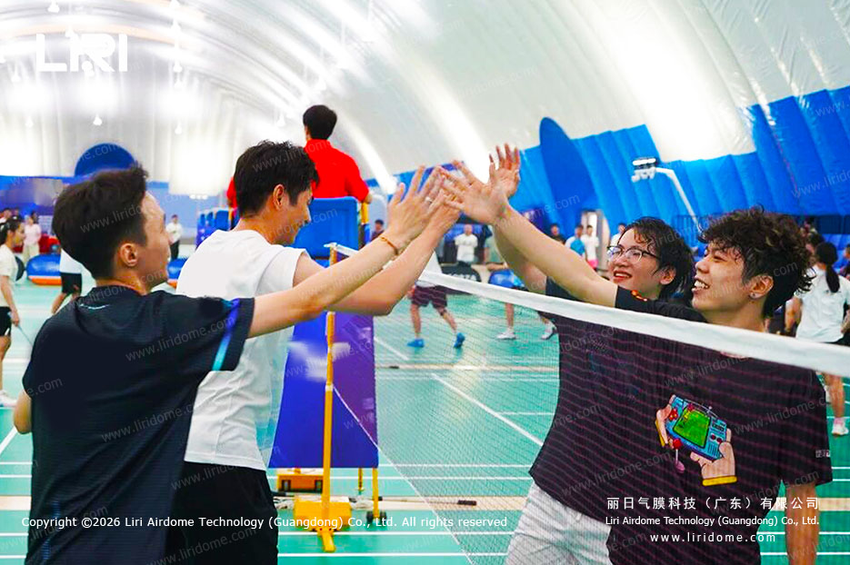 Students playing in an air dome campus sports hall during indoor training
