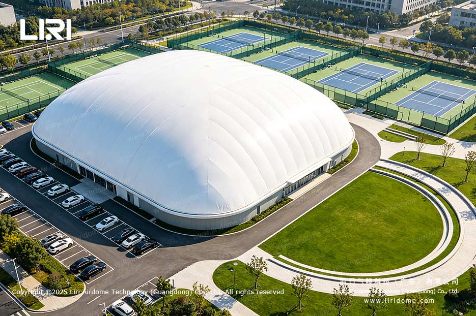 Aerial view of a LIRI air dome tennis center beside outdoor tennis courts