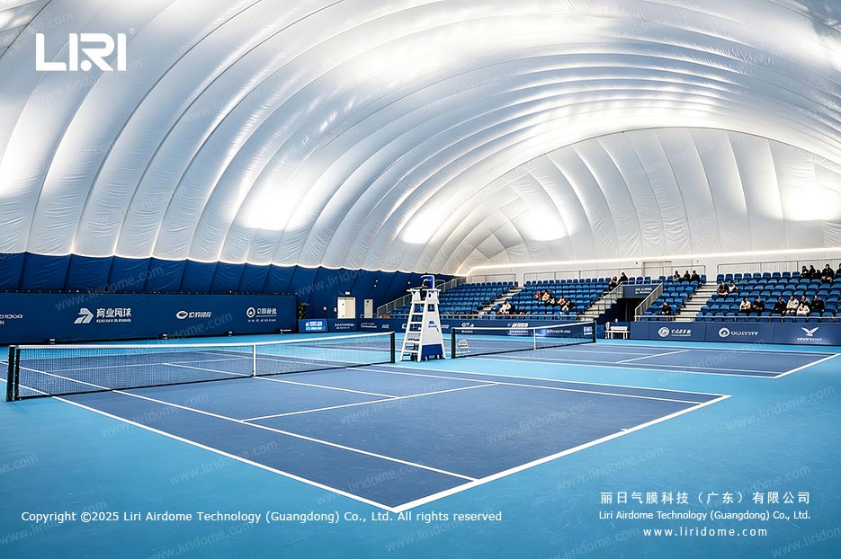 Indoor air dome tennis court with professional lighting and spectator seating